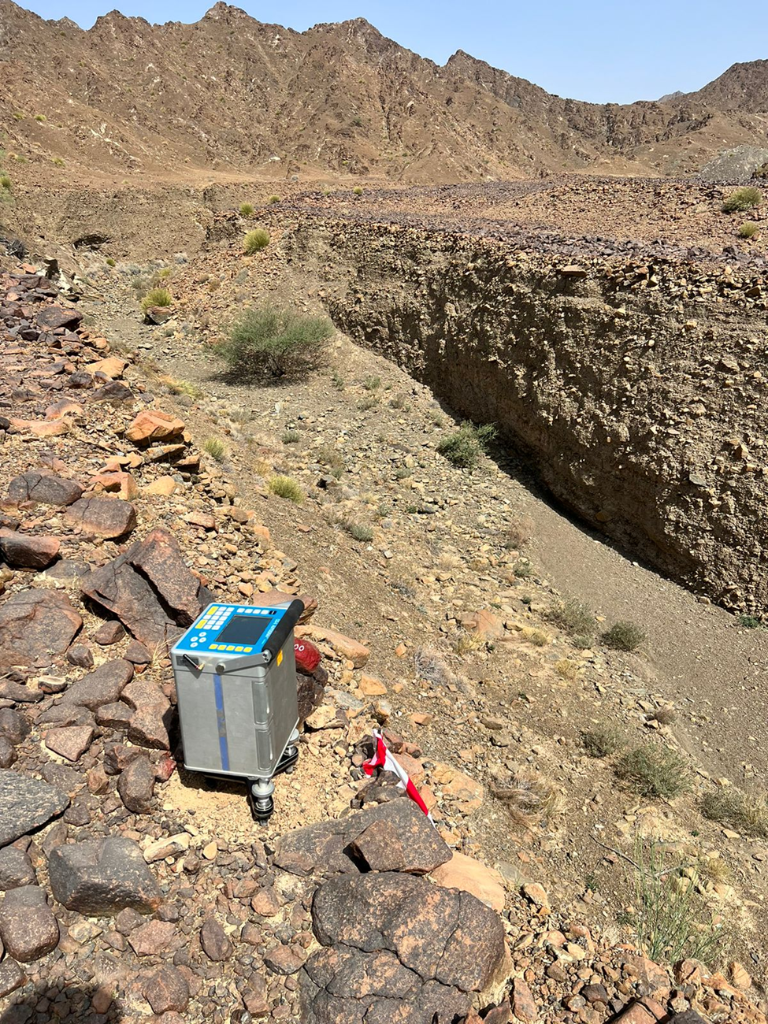 Gravity survey instrument in rocky trench field operations