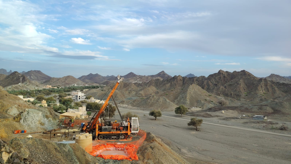 Drilling operations with mountain village panorama